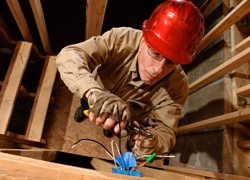 Electrician installing a new electrical outlet